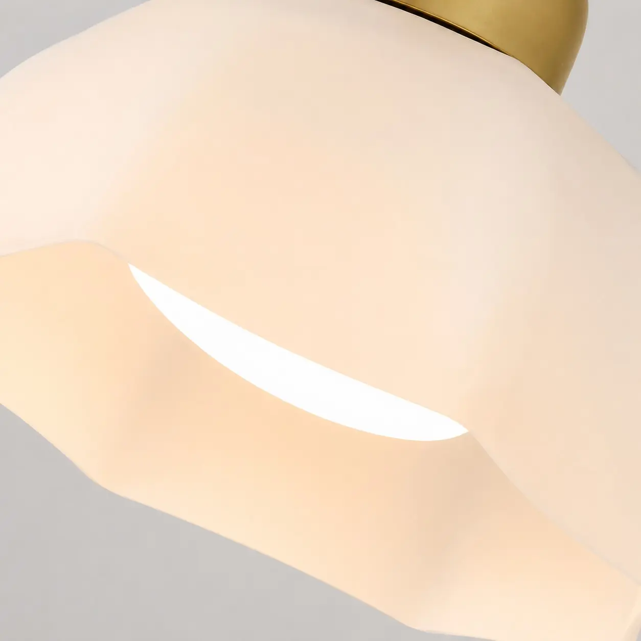 Close-up of the curved gold-tone metal frame